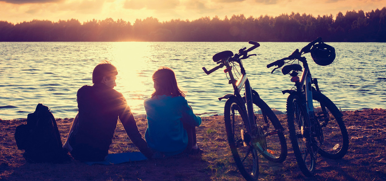 couple sitting by bicycle 'Port Bike Mallorca'